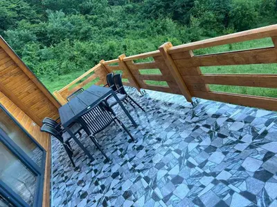 a patio with a table and a fence at Villa Forest Paradise in Visoko
