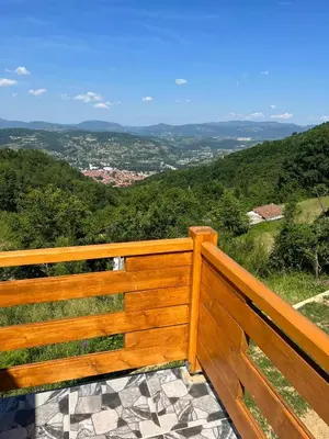 a wooden bench sitting on top of a hill at Villa Forest Paradise in Visoko
