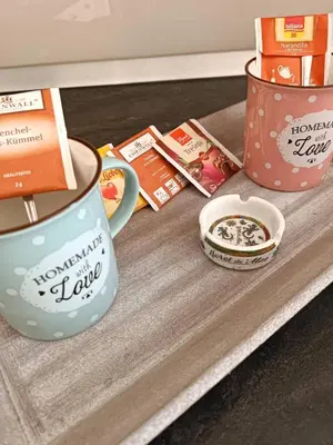 a table with a cup of coffee and other goodies at Apartman Slatina in Tuzla