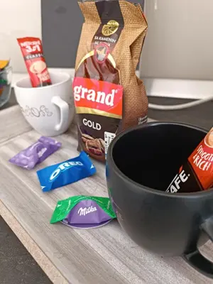 a counter with a bowl of food and a bag of chips at Apartman Slatina in Tuzla