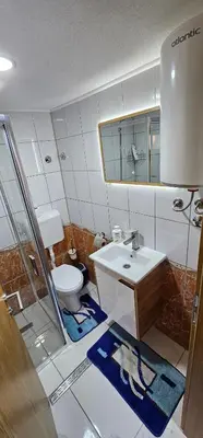 a bathroom with a sink and a toilet at Sobe Amar in Tuzla