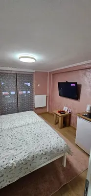 a bedroom with a bed and a flat screen tv at Sobe Amar in Tuzla