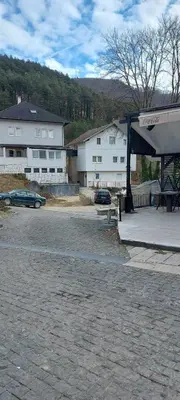 a gas station with a car parked in a parking lot at Apartman Heli Meli 1 in Jajce
