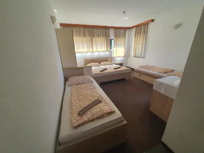 a room with three beds in a room at Hotel Irish in Bihać