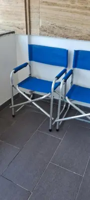 two blue and white chairs sitting next to a wall at Hotel Irish in Bihać