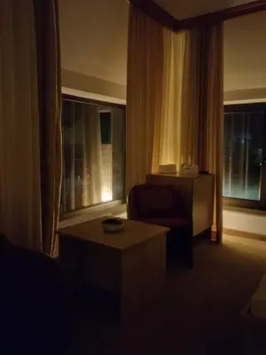 a living room with a chair and a coffee table at Hotel Irish in Bihać