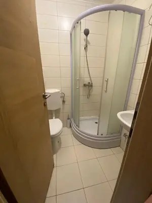 a bathroom with a shower and a toilet and a sink at Hotel Irish in Bihać