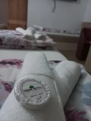 a pile of towels sitting on top of a bed at Hotel Irish in Bihać