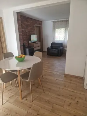 a living room with a table and chairs and a couch at Sofija, Guests House in Ključ