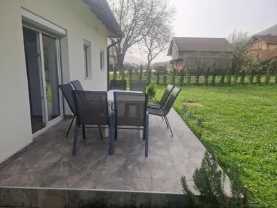 a table and chairs sitting on a patio at Sofija, Guests House in Ključ