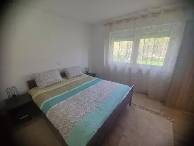 a bedroom with a bed and a window at Sofija, Guests House in Ključ