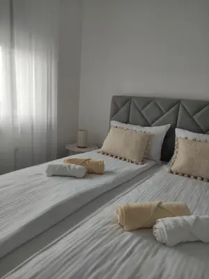a large white bed with two pillows on it at Apartman Ella in Banja Luka
