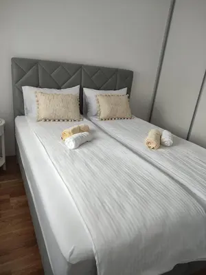 a large white bed with two pillows on it at Apartman Ella in Banja Luka