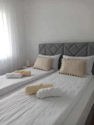 a large white bed with two pillows on it at Apartman Ella in Banja Luka