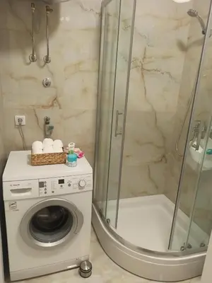 a bathroom with a washing machine and a shower at Apartman Ella in Banja Luka