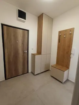 an empty room with a door and a drawer and a box at Apartman Ella in Banja Luka