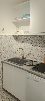 a kitchen with a sink and a counter top at Plavi studio in Banja Luka