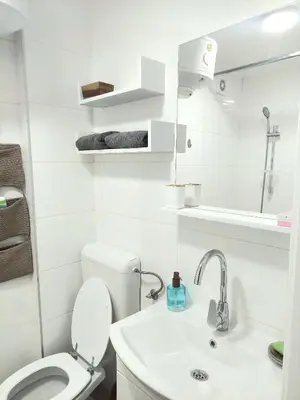 a white bathroom with a toilet and a sink at Plavi studio in Banja Luka