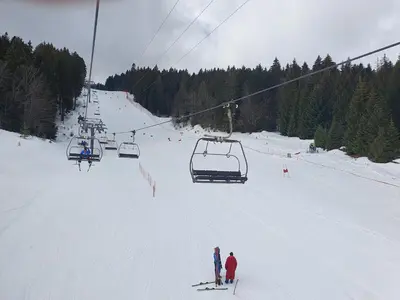 a group of people on a ski lift in the snow at Apartman Lena in Kupres