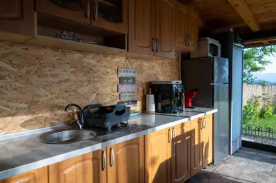 a kitchen with a sink and a refrigerator at Vidikovac Cazin in Cazin