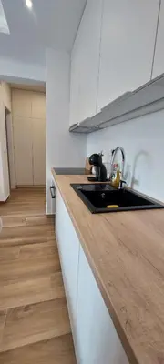a kitchen with a sink and a counter top at Stan na dan Borik Banja Luka in Banja Luka