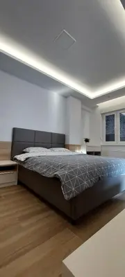 a bedroom with a large bed in a room at Stan na dan Borik Banja Luka in Banja Luka