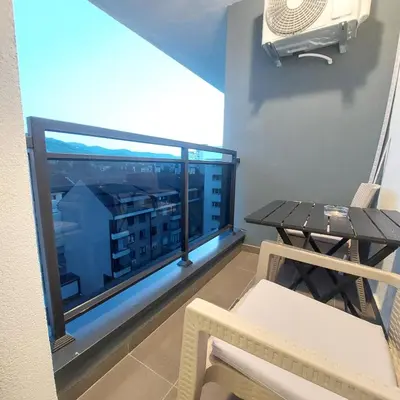 a balcony with a table and a view of a city at Stan na dan Borik Banja Luka in Banja Luka
