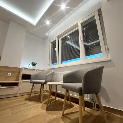 a kitchen with two chairs and a table and a window at Stan na dan Borik Banja Luka in Banja Luka