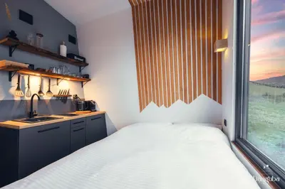 a bedroom with a bed and a large window at Tiny Glamp House - DANGUBA by IGLENA in Kupres