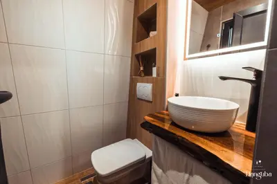 a bathroom with a white sink and a toilet at Tiny Glamp House - DANGUBA by IGLENA in Kupres