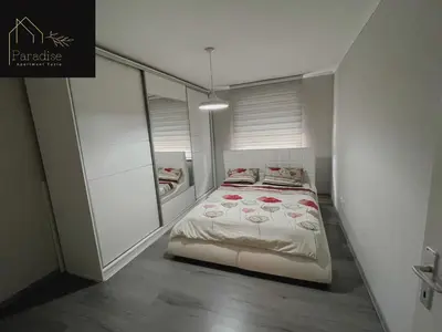 a small bedroom with a bed and a closet at Apartment Paradise in Tuzla