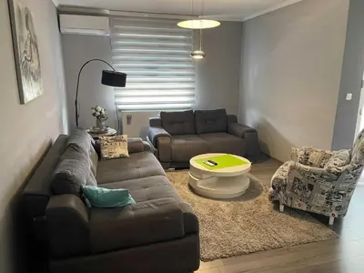 a living room with a couch and a coffee table at Apartment Paradise in Tuzla