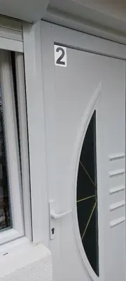 a door with a window with the number two on it at Apartman Heli Meli 2 in Jajce