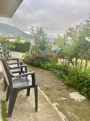 a row of park benches sitting on a sidewalk at Stan na dan Tomic in Rebrovac