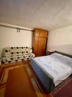 an empty room with a bed and a couch at Stan na dan Tomic in Rebrovac
