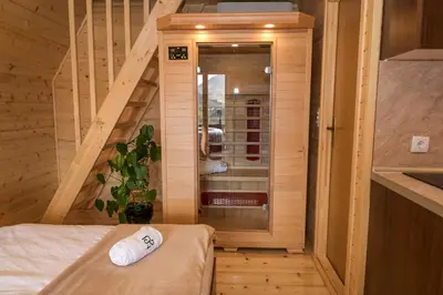 a small room with a bed and a staircase at Cottages Relax in Jajce