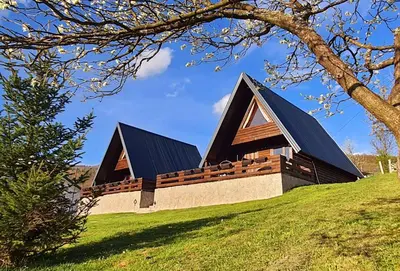 a house on a hill with a black roof at Cottages Relax in Jajce