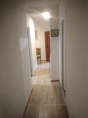 an empty hallway with a hallway leading to a room at Hostel Mlinar in Bihać