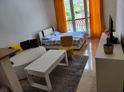a living room with a couch and a table at Apartman M&M in Travnik