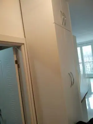 a white cabinet in a room with a window at Apartman M&M in Travnik