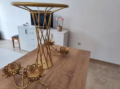 a wooden table with gold decorations on top of it at Apartman M&M in Travnik
