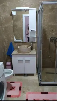 a bathroom with a sink and a toilet and a mirror at Apartman M&M in Travnik
