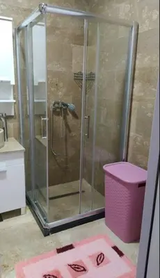 a shower with a glass door in a bathroom at Apartman M&M in Travnik