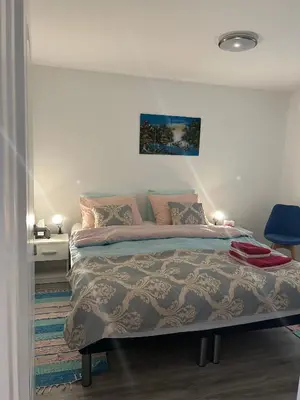 a bedroom with a bed and a blue chair at Villa 46 - little heaven in Banja Luka