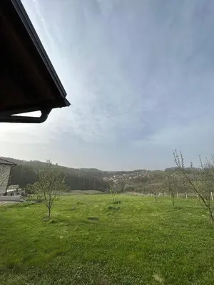 a field of green grass with trees in the background at Villa 46 - little heaven in Banja Luka