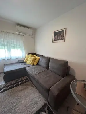 a living room with a brown couch and a table at Villa 46 - little heaven in Banja Luka