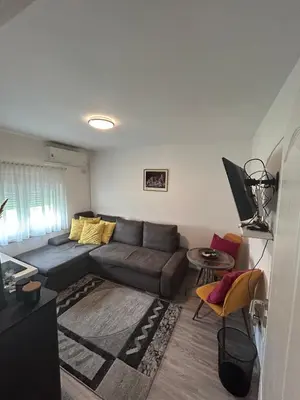 a living room with a couch and a table at Villa 46 - little heaven in Banja Luka