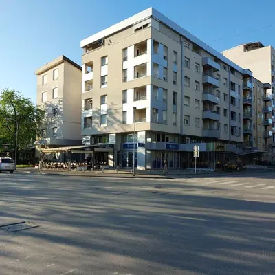 a building on the corner of a street at Index Apartman in Banja Luka