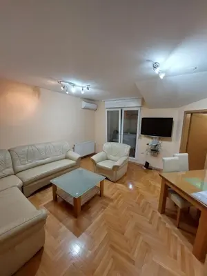 a living room with a couch and a table at Index Apartman in Banja Luka