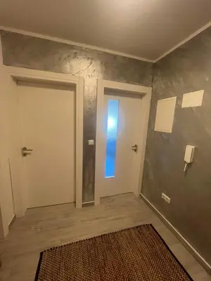 a hallway with a door with a blue window at Una-No1 in Bihać